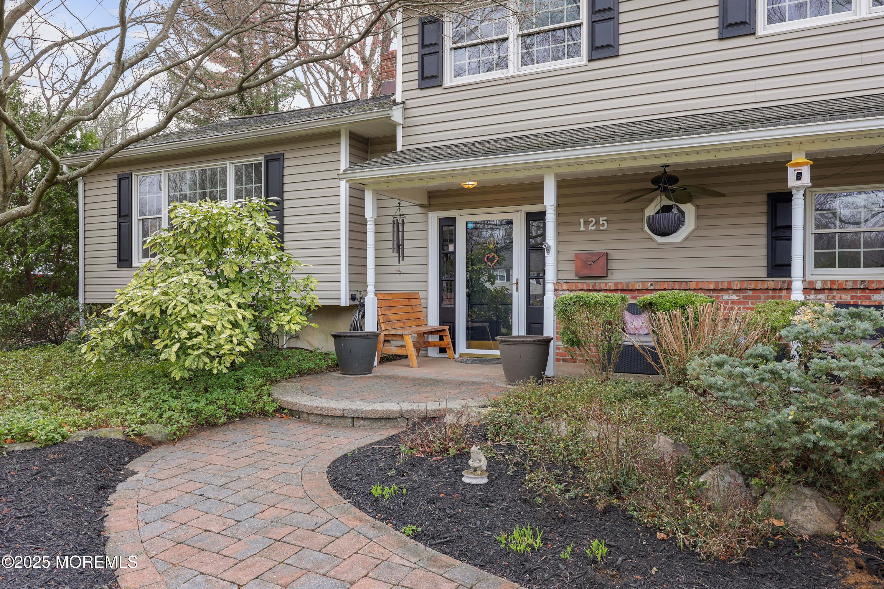 125 Jumping Brook Road Lincroft, NJ 07738 - Photo 10 of 47 a front view of a house with garden