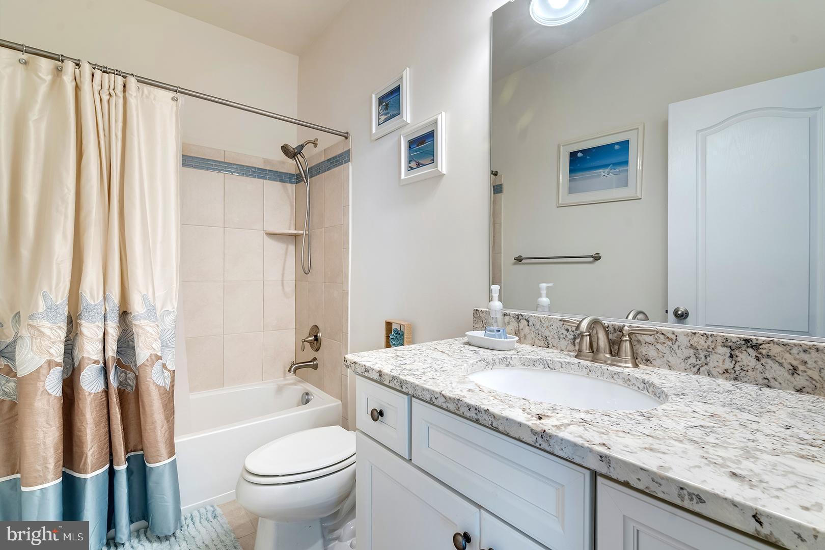 34438 Spring Brook Avenue Lewes, DE 19958 - Photo 25 of 58 a bathroom with a granite countertop sink toilet and shower