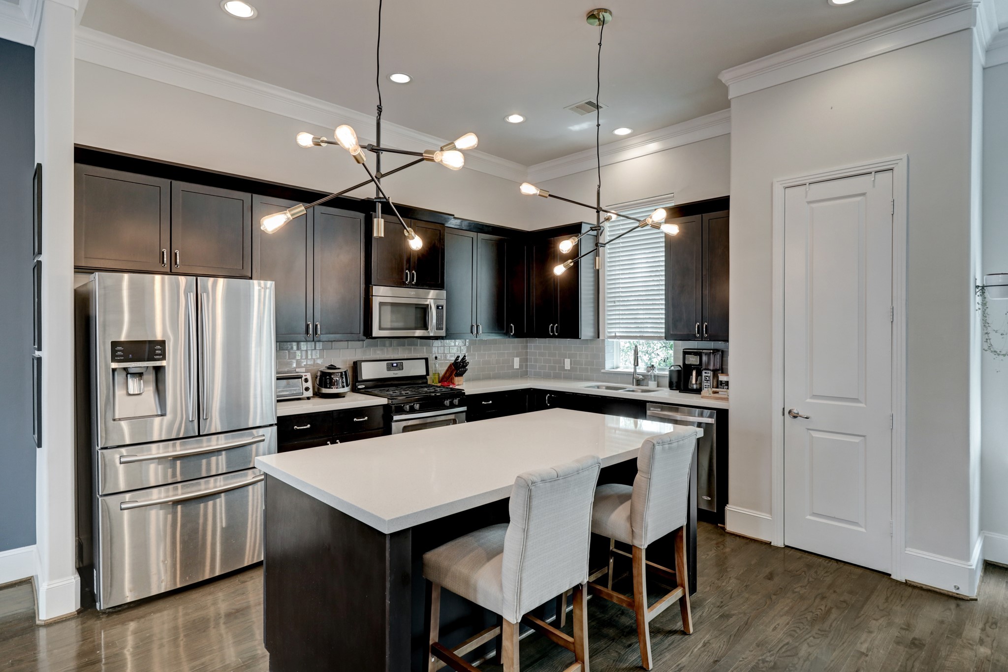 2231 Chenevert Street Houston, TX 77003 - Photo 10 of 26 a kitchen with a center island a counter space cabinets and stainless steel appliances