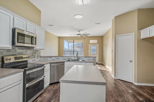 a kitchen with a stove sink and microwave
