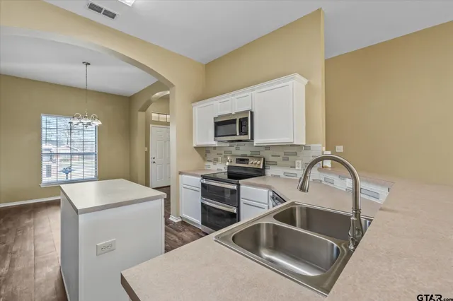 a kitchen that has a sink and a stove in it