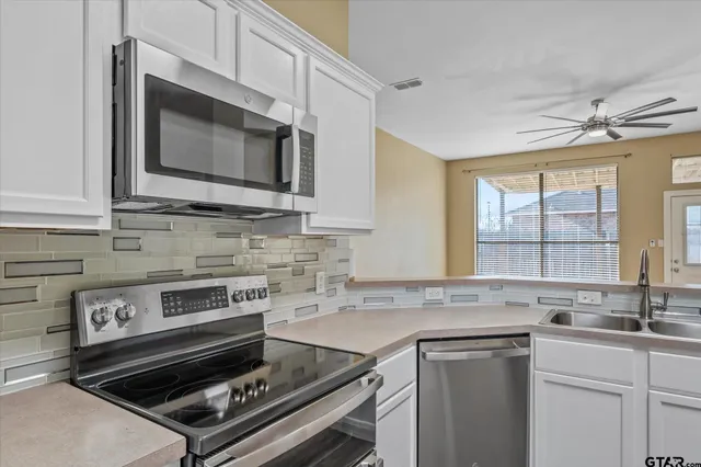 a kitchen with a stove and a sink