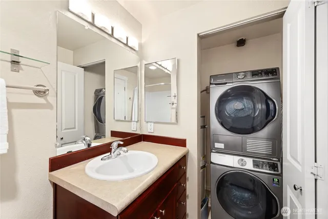 a bathroom with a sink a washer and dryer
