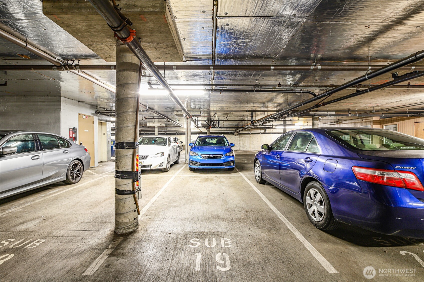 566 Prospect Street, Unit 209 Seattle, WA 98109 - Photo 14 of 16 a view of parking garage with cars parked