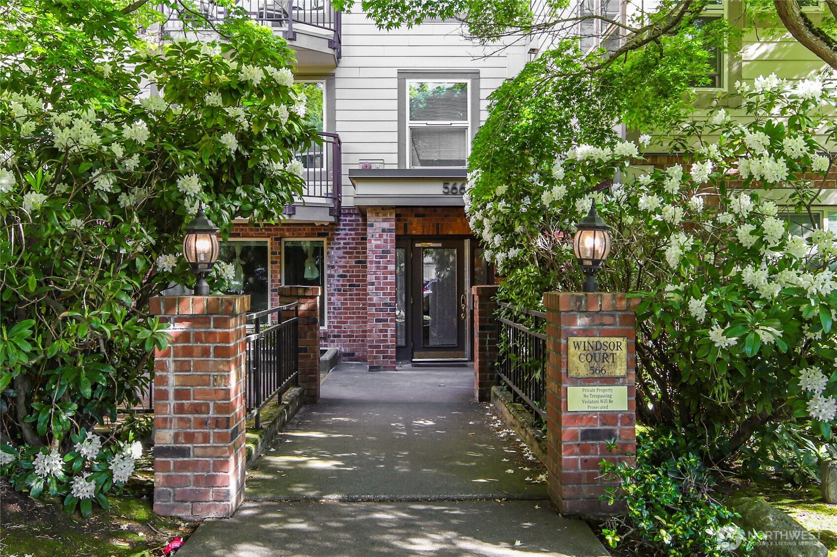 566 Prospect Street, Unit 209 Seattle, WA 98109 - Photo 2 of 16 a front view of a house with a tree