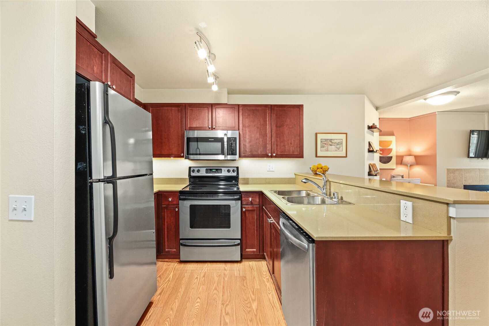 566 Prospect Street, Unit 209 Seattle, WA 98109 - Photo 5 of 16 a kitchen with stainless steel appliances granite countertop a sink stove microwave and refrigerator