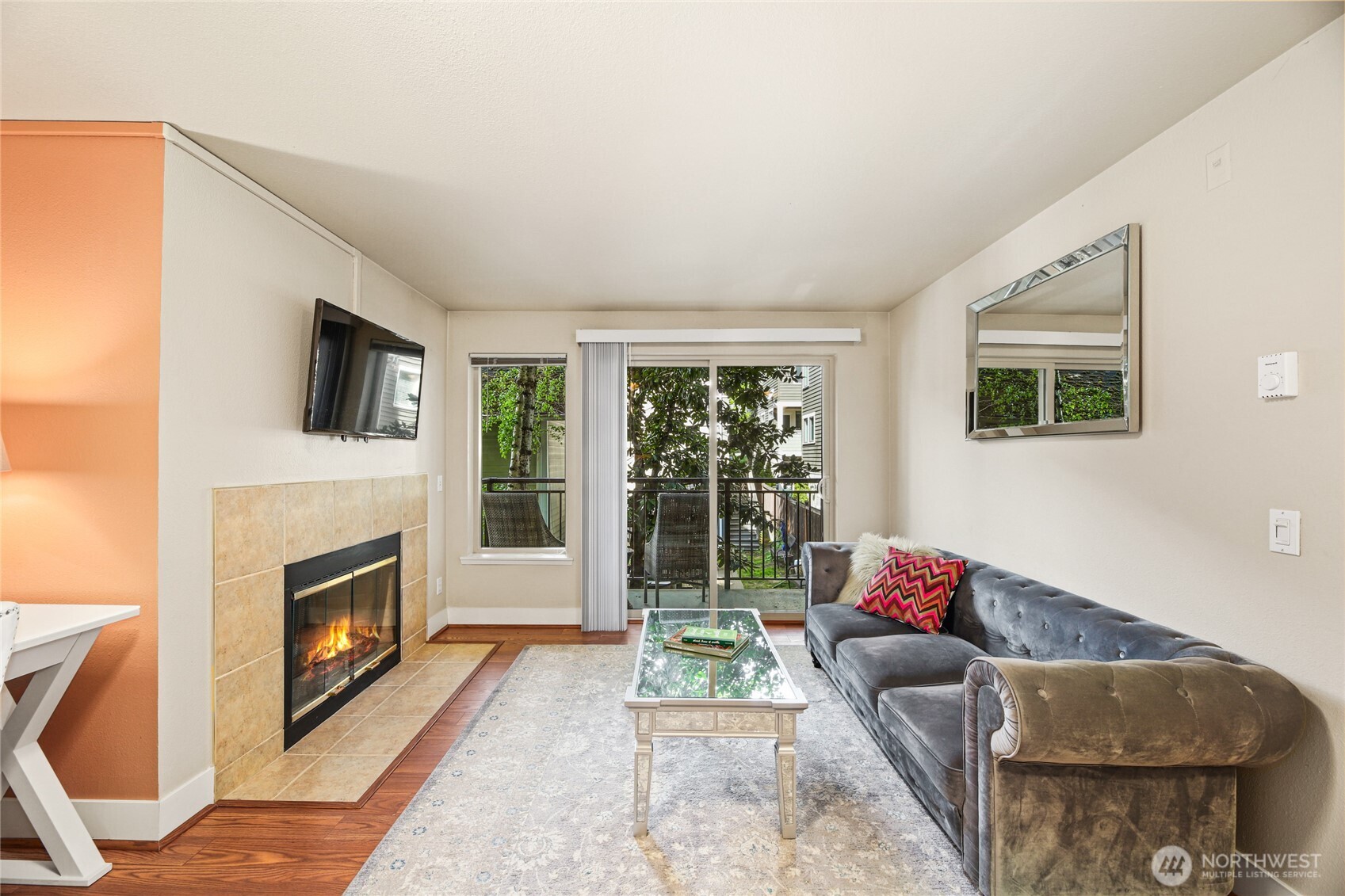 566 Prospect Street, Unit 209 Seattle, WA 98109 - Photo 8 of 16 a living room with furniture a flat screen tv and a fireplace