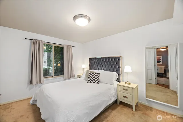 a bedroom with a large bed and a large window