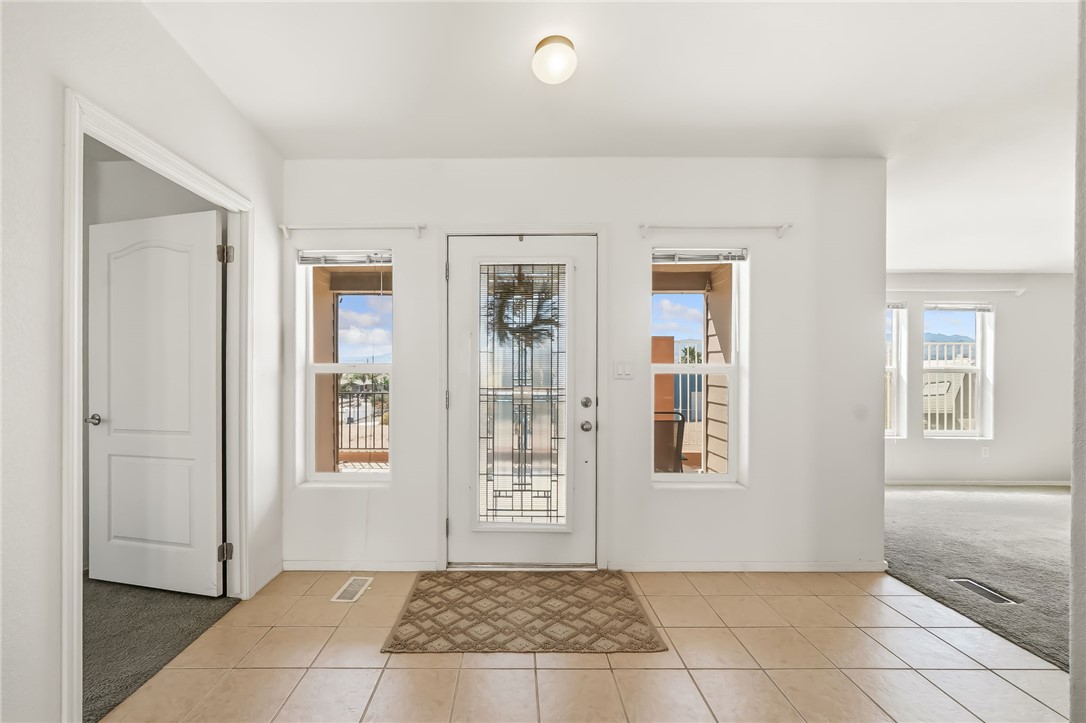 2525 South Ridge Avenue Bullhead City, AZ 86429 - Photo 13 of 76 Front entry featuring a leaded glass door, two sidelight windows, and light-toned tile flooring