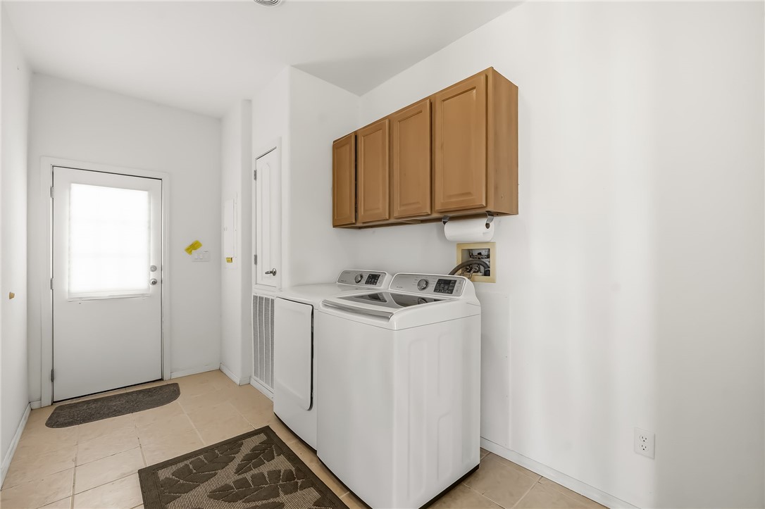 2525 South Ridge Avenue Bullhead City, AZ 86429 - Photo 59 of 76 Utility area featuring tile flooring, a built-in storage cabinet, and upper wood-finish cabinetry