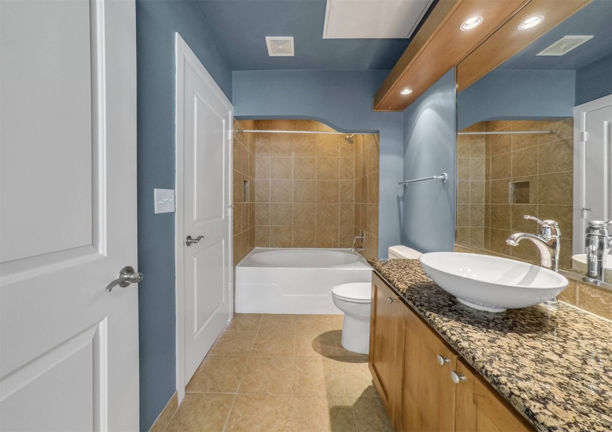 1010 Rosine Street, Unit 22 Houston, TX 77019 - Photo 13 of 21 a bathroom with a granite countertop sink a toilet a mirror and bathtub