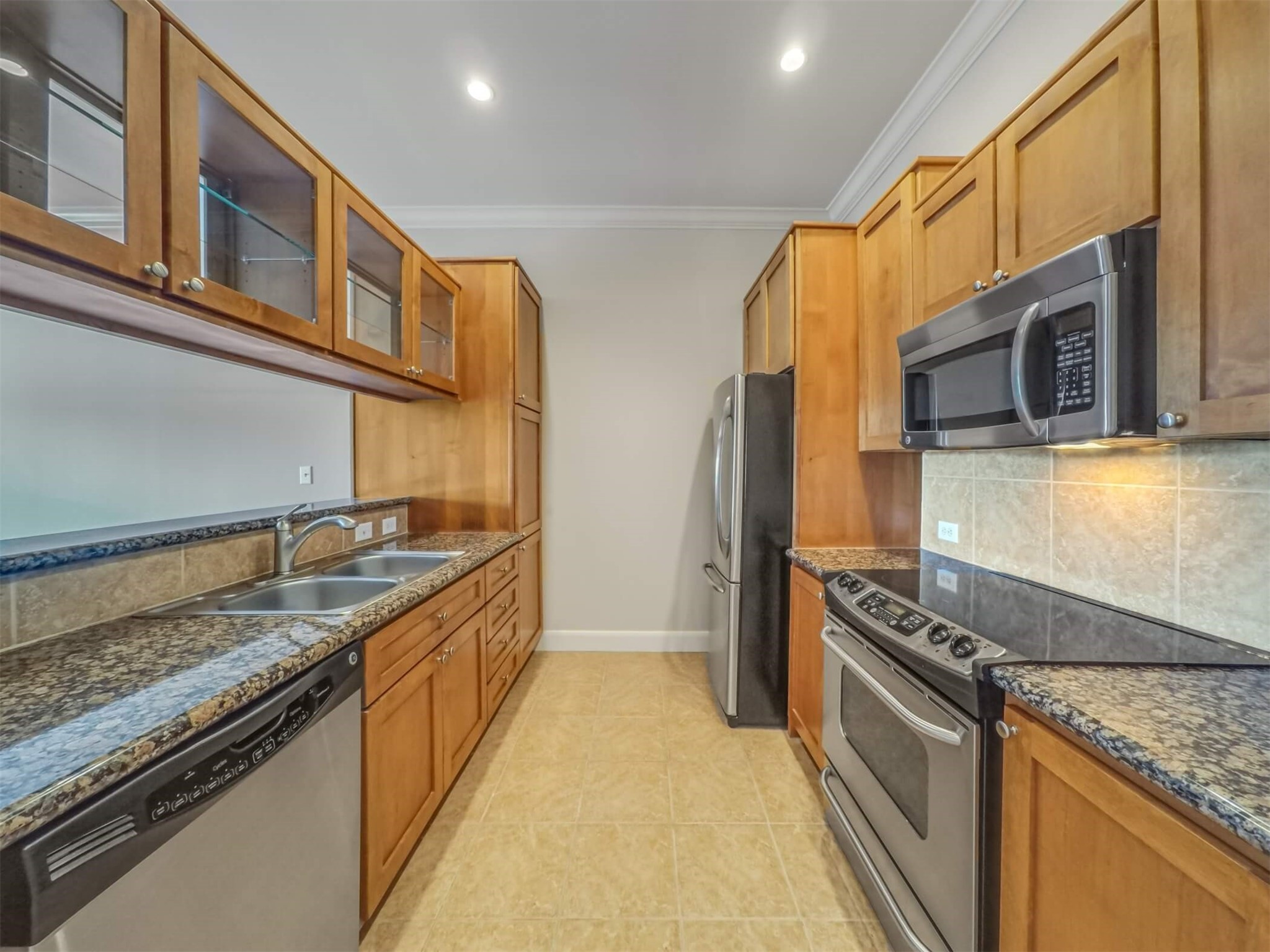 1010 Rosine Street, Unit 22 Houston, TX 77019 - Photo 6 of 21 a kitchen with stainless steel appliances granite countertop a stove a sink and a refrigerator