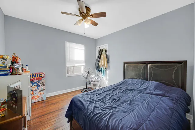 a bedroom with a bed and wooden floor