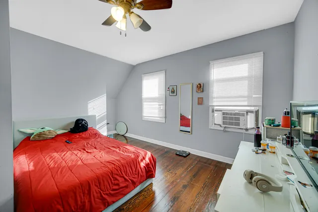 a bed sitting in a bedroom next to a window