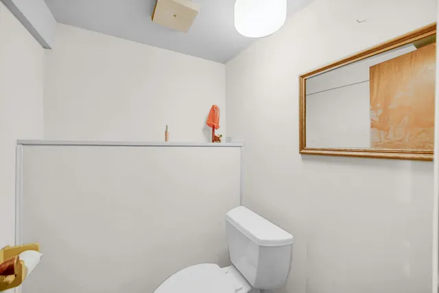 a white toilet sitting next to a bathroom sink