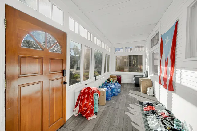 a living room with furniture and a floor to ceiling window