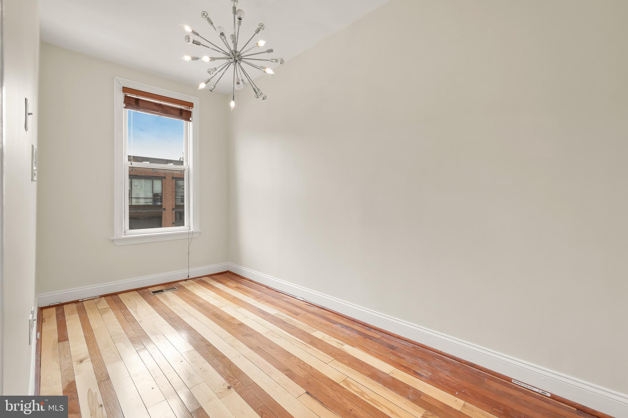 730 15th Street Southeast, Unit 2 Washington, DC 20003 - Photo 11 of 16 a view of an empty room with window and chandelier fan