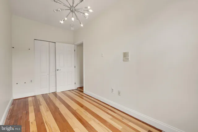 a view of a room with wooden floor and fan