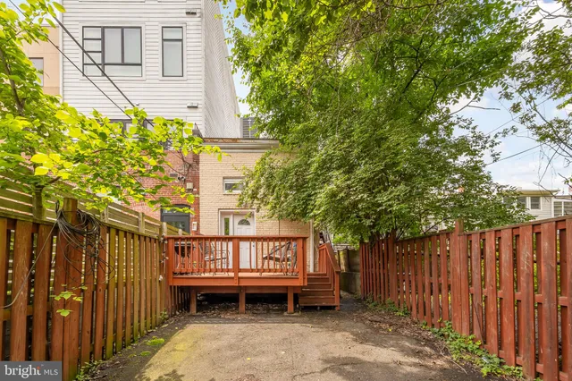 a backyard of a house with a table and chairs