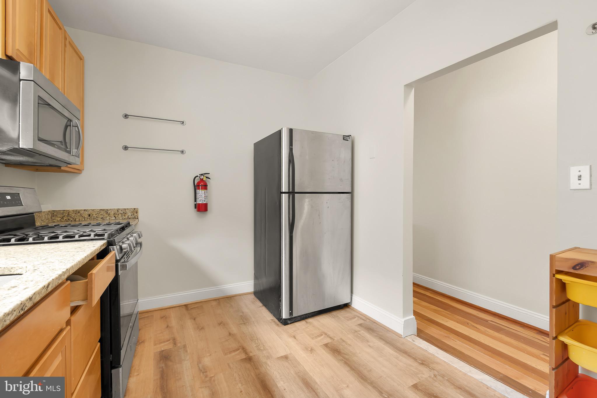 730 15th Street Southeast, Unit 2 Washington, DC 20003 - Photo 4 of 16 a kitchen with a refrigerator and a stove