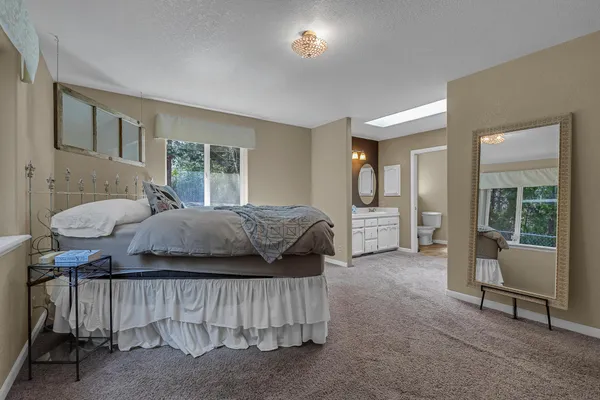 a bedroom with a bed and a mirror