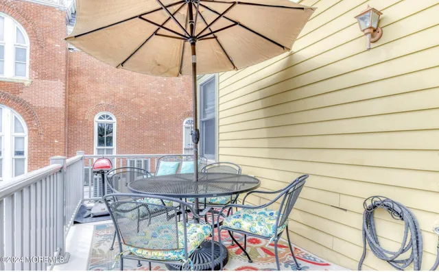 a table and chairs in patio of a house