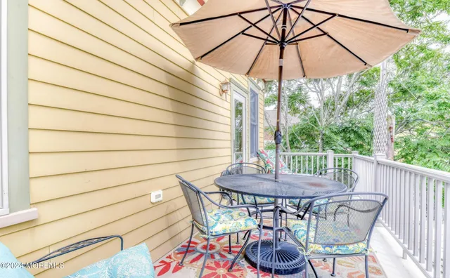 a view of a patio with a table and chairs under an umbrella