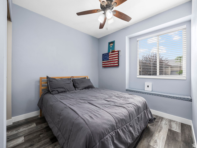 392 West Bricker Road Draper, UT 84020 - Photo 21 of 33 Room featuring a ceiling fan with integrated lighting, wood-finish flooring, and a large window with horizontal blinds