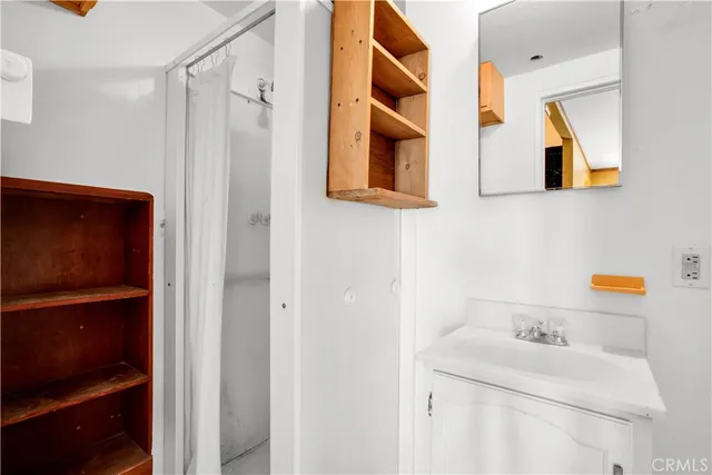 an empty room with a window and doors