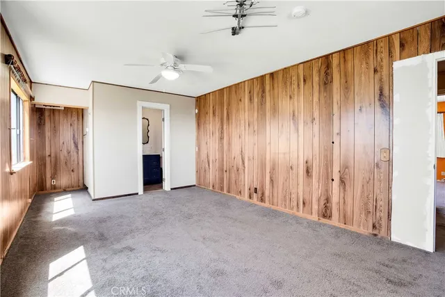 a view of a terrace with lawn chairs