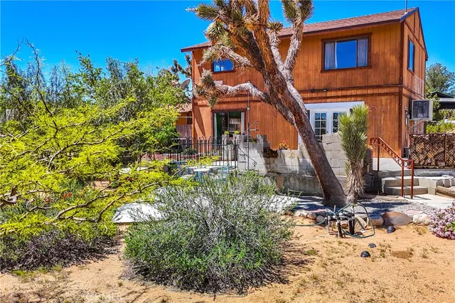 a view of a house with a tree