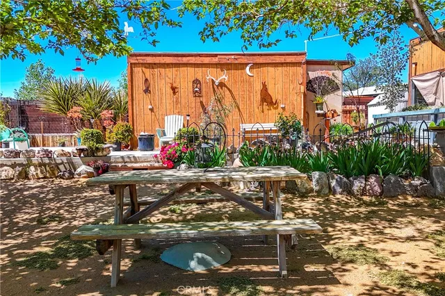 a view of a house with a wooden fence