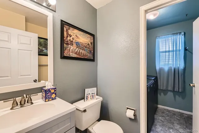 a bathroom with a toilet a sink and a mirror