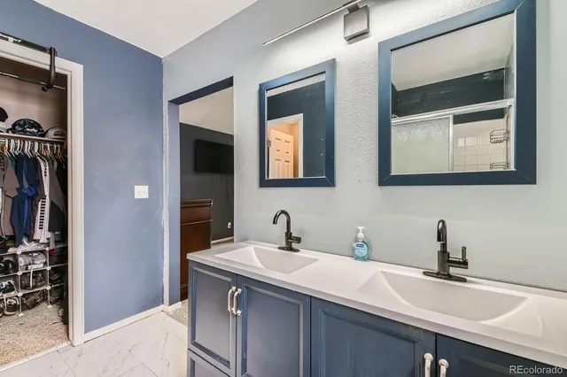 a bathroom with a sink and two mirror