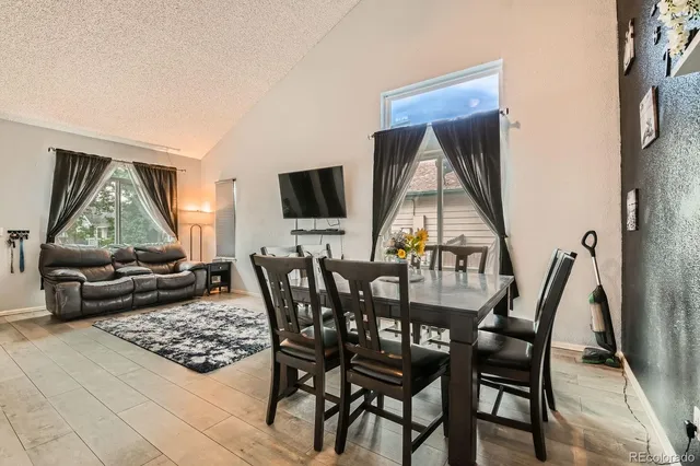 a view of a dining room with furniture and a window
