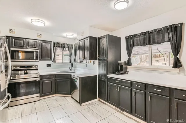 a kitchen with stainless steel appliances granite countertop a sink and stove top oven