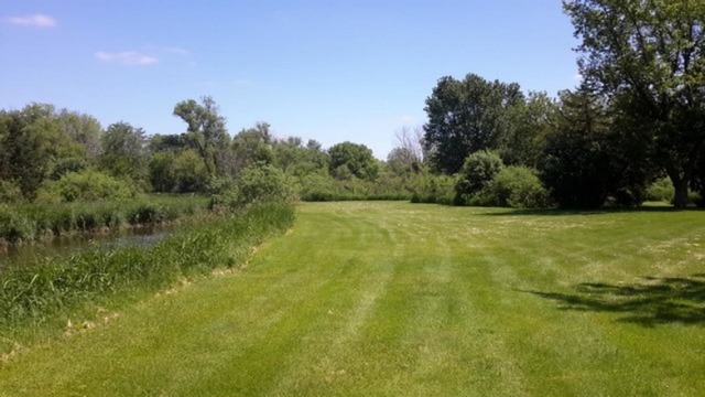 8225 Galena Road Bristol, IL 60512 - Photo 3 of 5 a view of a field with trees in the background
