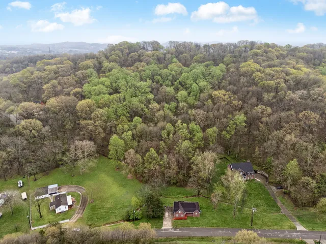 an aerial view of a house with yard