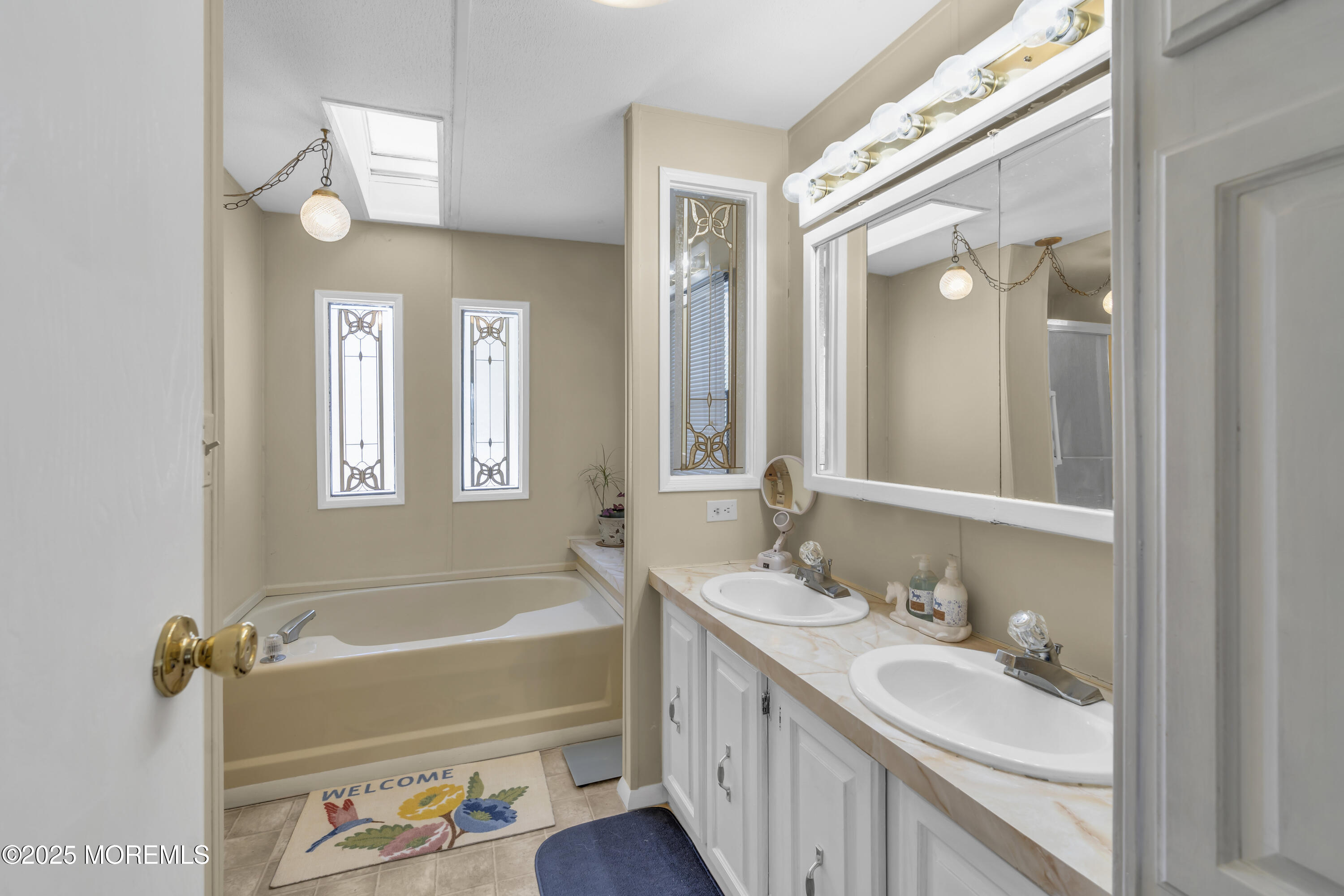 9 Greenway Trail Cream Ridge, NJ 08514 - Photo 12 of 19 a bathroom with a tub a sink and a mirror