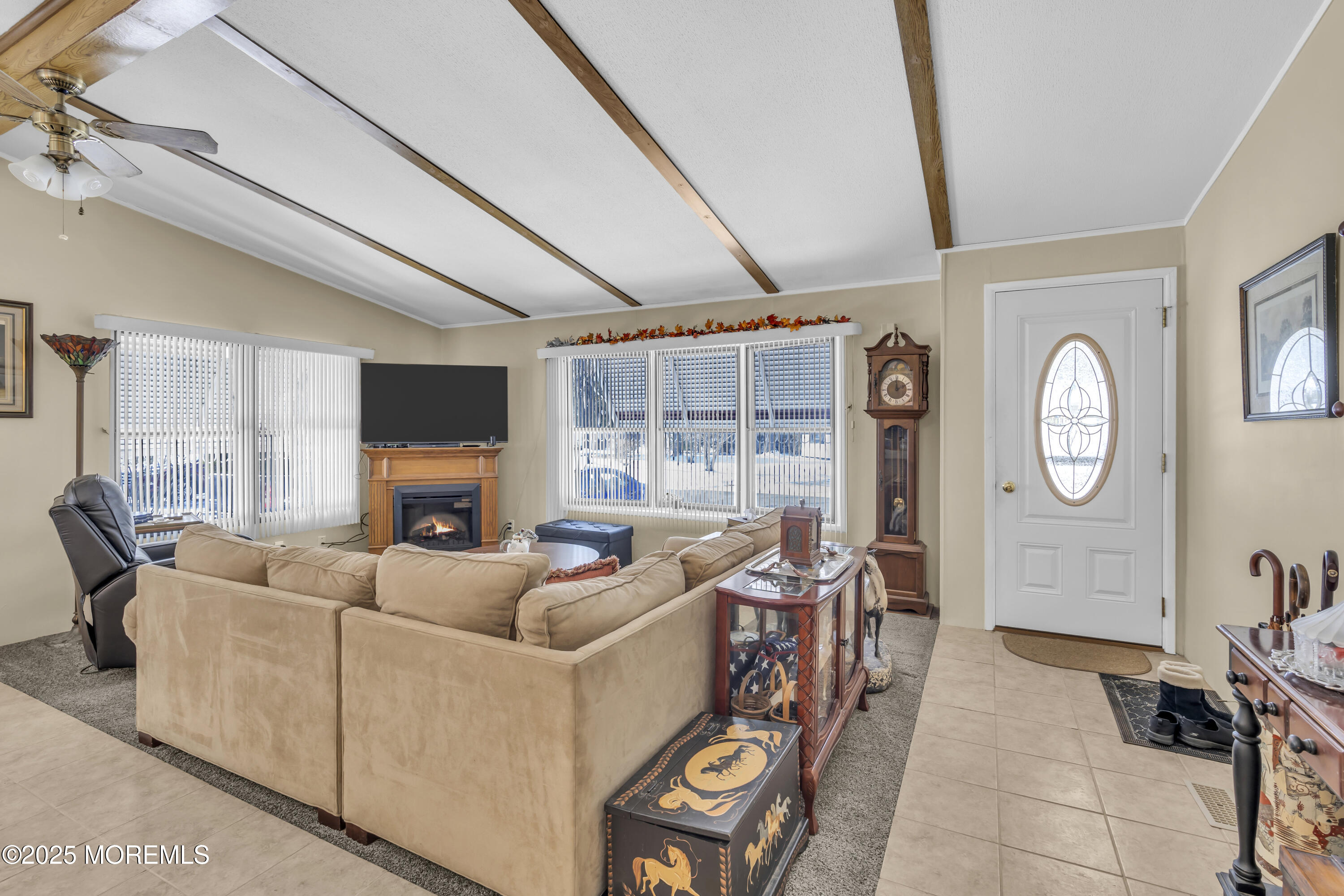 9 Greenway Trail Cream Ridge, NJ 08514 - Photo 3 of 19 a living room with furniture a flat screen tv and a large window