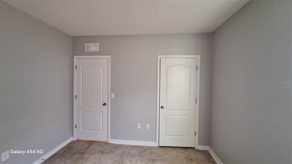 754 Chinoy Road Davenport, FL 33837 - Photo 2 of 26 a view of an empty room