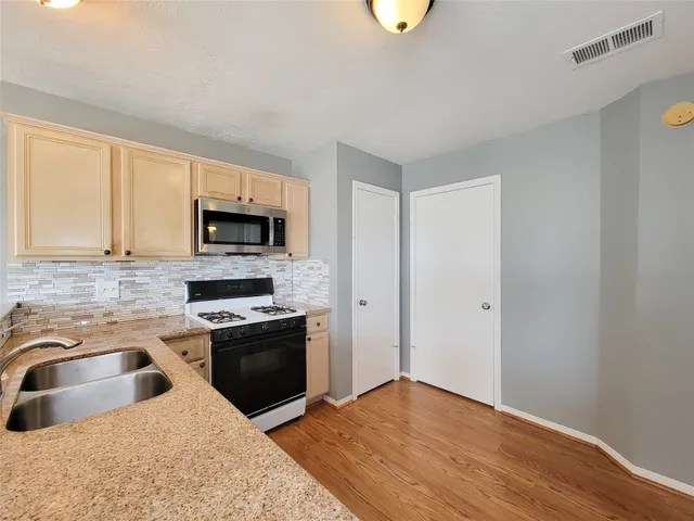 a kitchen with a sink cabinets and stainless steel appliances