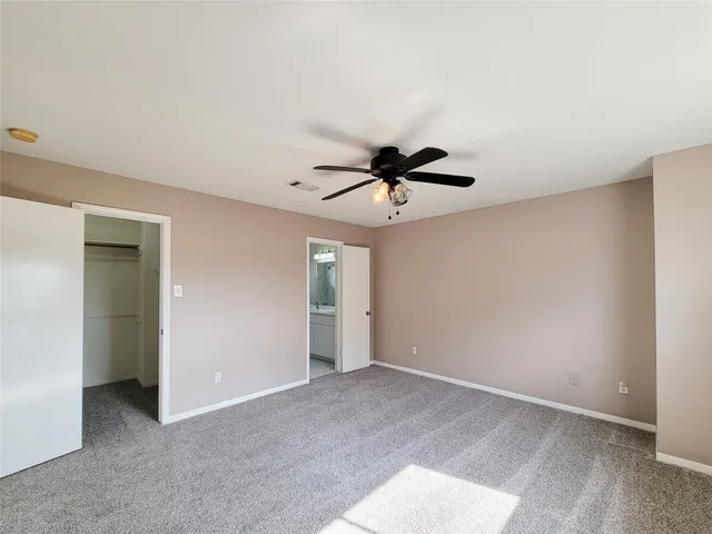 a view of room with a ceiling fan and a window