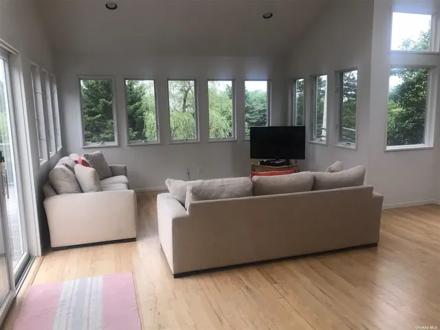 a bed sitting in a bedroom next to a lamp