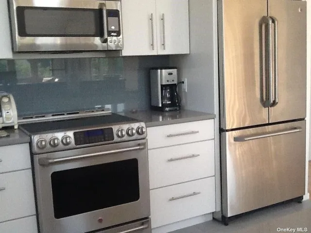 a kitchen with a sink and large window