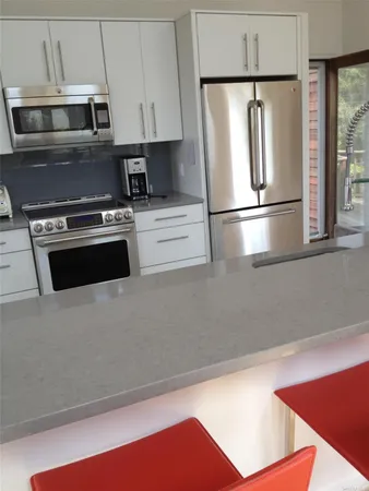 a kitchen with stainless steel appliances a stove and a refrigerator