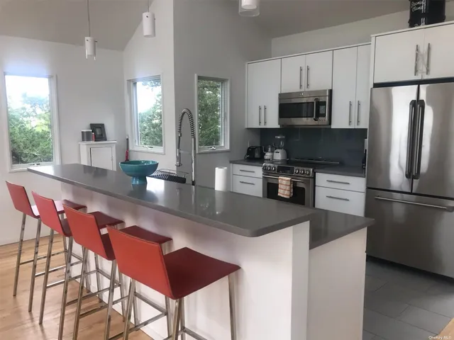 a blue kitchen with table and chairs