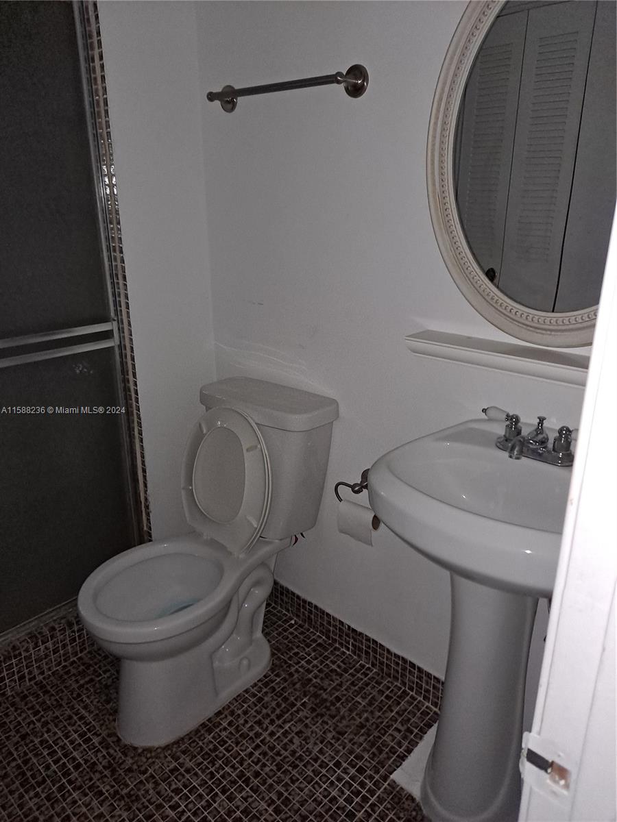 Buckley Towers Miami, FL 33179 - Photo 6 of 10 a white toilet sitting next to a bathroom sink