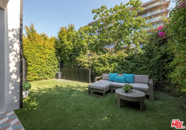 a backyard of a house with outdoor seating