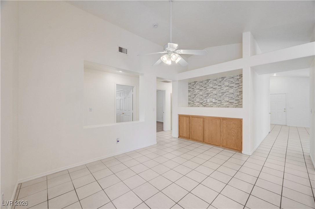 9929 Princess Cut Street Las Vegas, NV 89183 - Photo 13 of 52 Tiled empty room with lofted ceiling and a ceiling fan
